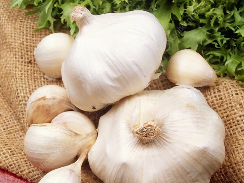 garlic-bulbs Several garlic bulbs arranged on burlap